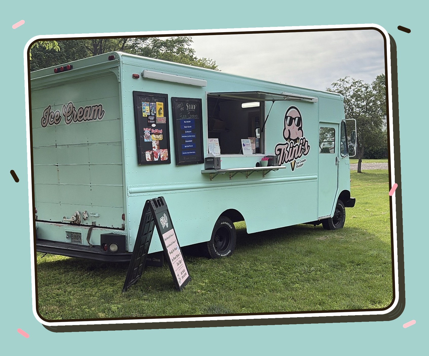 Trini's Ice Cream Shoppe mint-green ice cream truck parked on grass with the Trini's mascot logo on the side